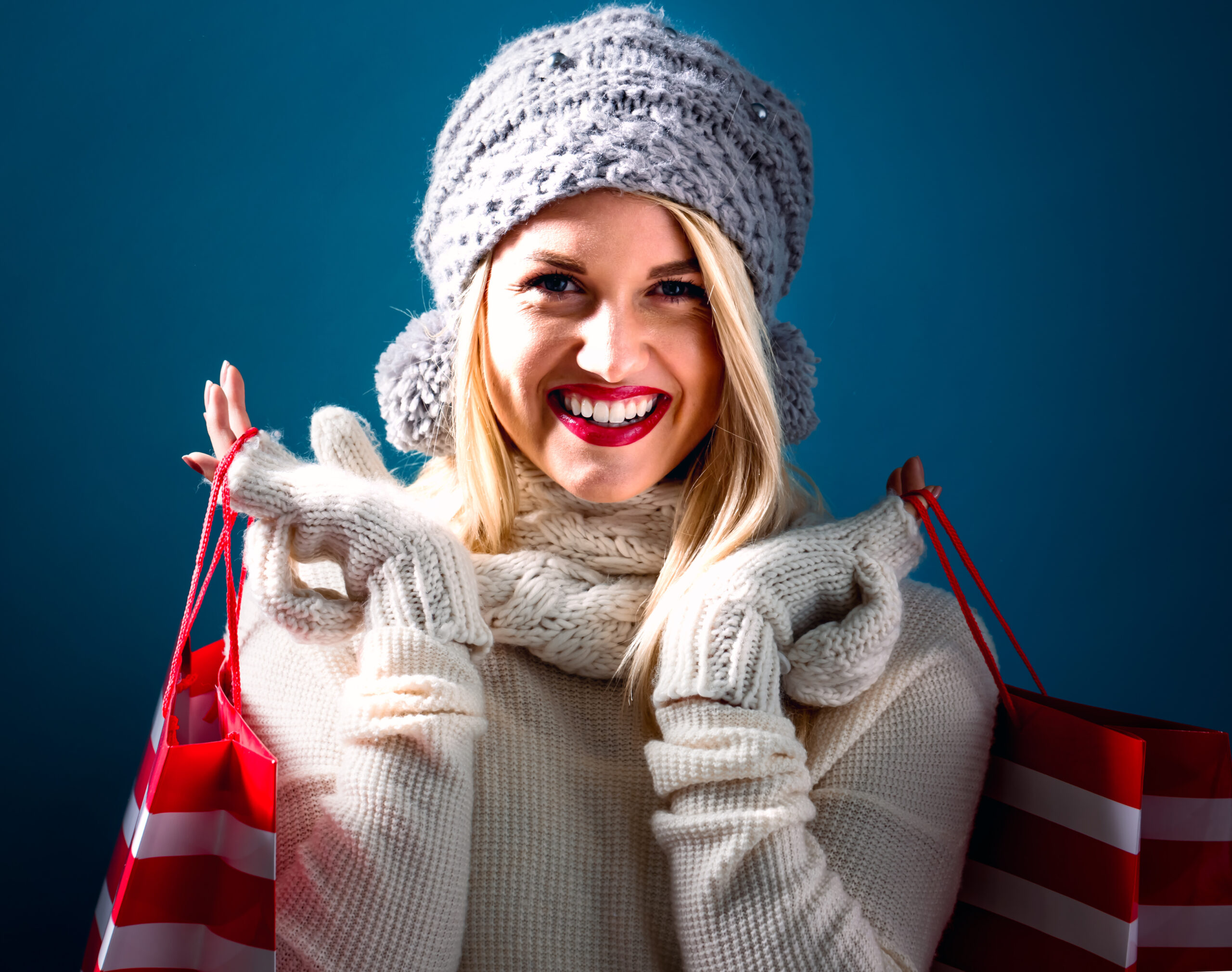 Happy young woman holding shopping bags